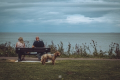 Couple on the coastline bench